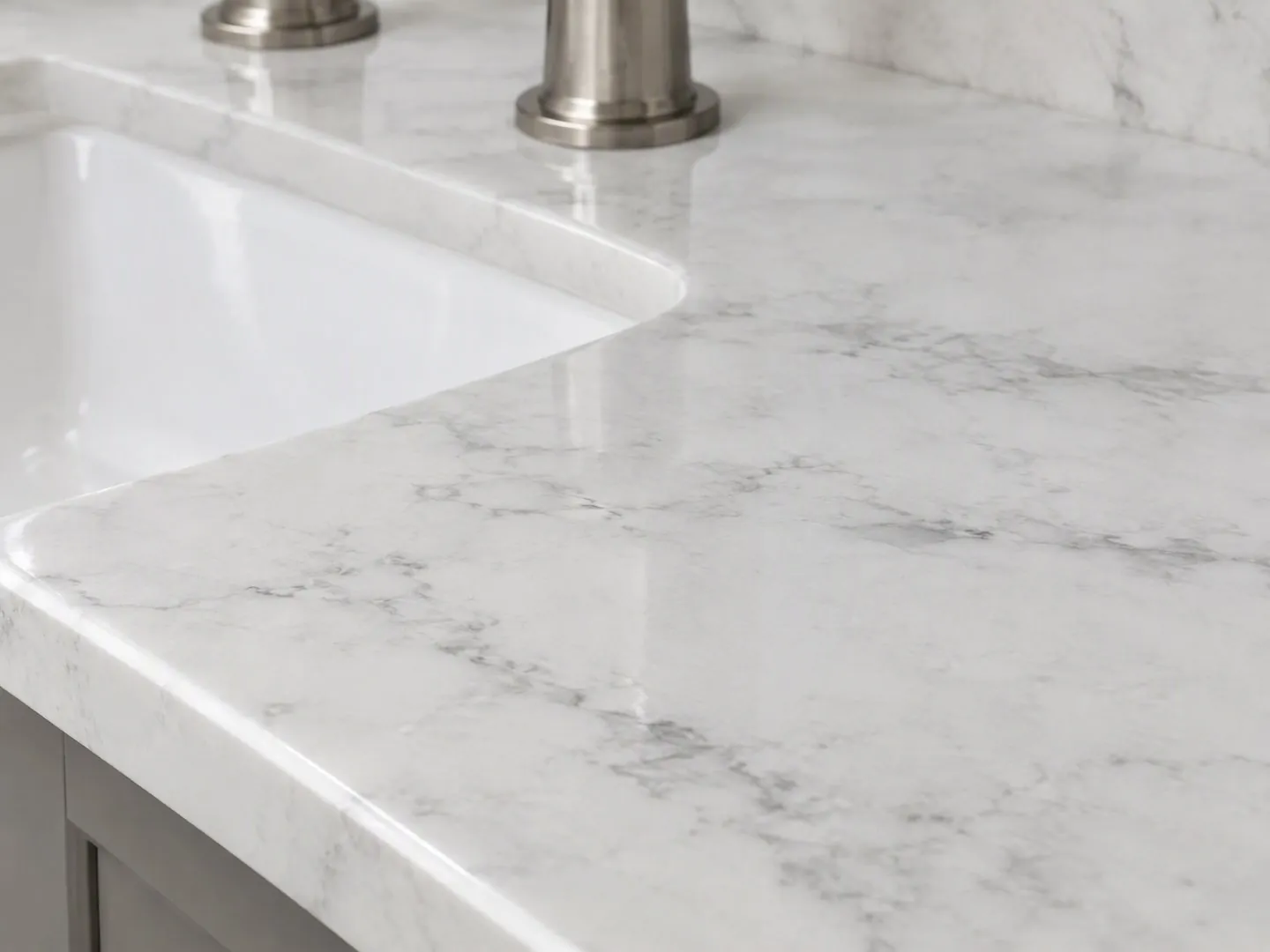 Render close-up of an Impact Carrara Cloud-style pale quartz top with fine gray veining and a stainless faucet